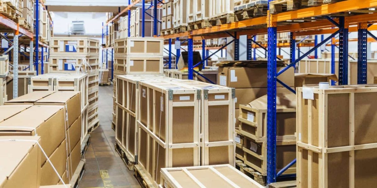 up-rows-of-shelves-filled-with-cardboard-boxes-wareh-2022-03-16-01-52-17-utc-min.jpg "Rows of shelves filled with stock – Trusted UK wholesale supplier for Amazon FBA and retail businesses."